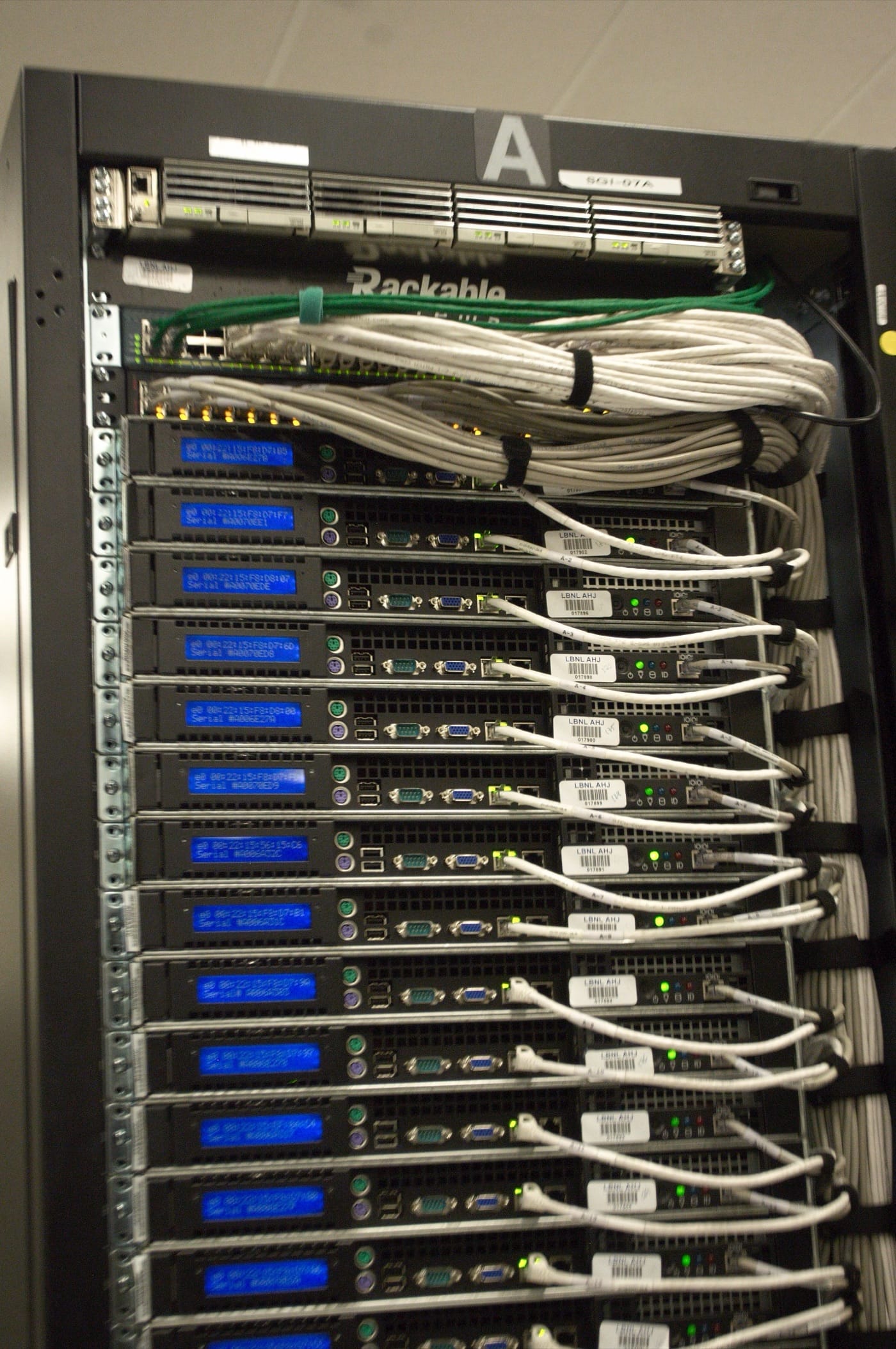 The rear of a server rack at the NERSC data center, photographed by Derrick Coetzee and released under CC0, used as the inline image for a ThriveInMarkets review of how chip receivables, cloud backlogs, and two AI labs fund one another