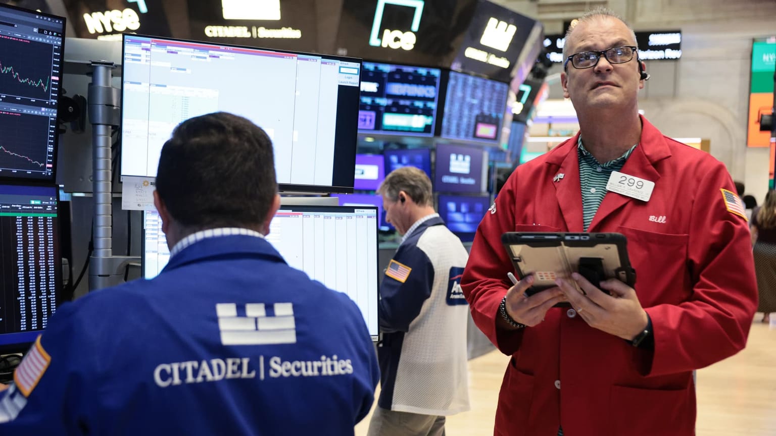 Traders on the floor of the New York Stock Exchange watching screens on Monday July 27 2026, the session the Dow closed up 262 points on an oil crash while a Nvidia-led chip selloff dragged the Nasdaq Composite lower into a live Federal Reserve week