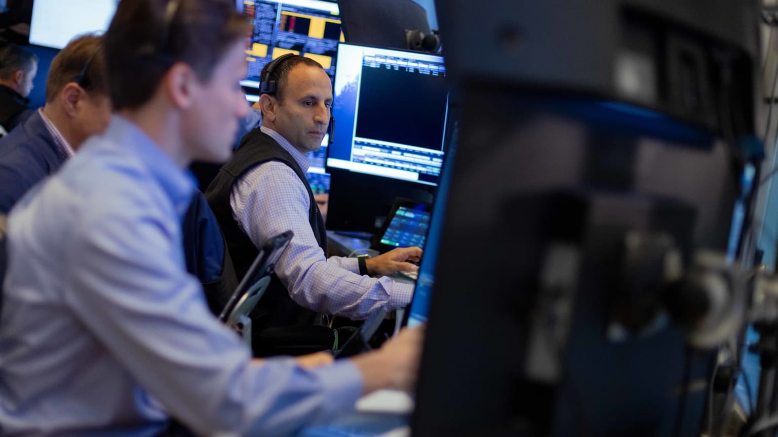 Traders wearing headsets work screens on the New York Stock Exchange floor, used as the ThriveInMarkets evening-review hero for Thursday September 3 2026, when the S&P 500 closed 7,748, up 1.06 percent, after Fed Governor Christopher Waller said he was inclined to hold rates in September if August inflation keeps cooling and Bitcoin reclaimed 81,500 dollars
