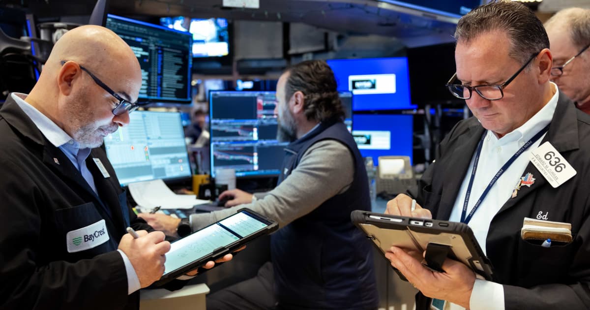 Traders on the floor of the New York Stock Exchange as markets react to oil shock