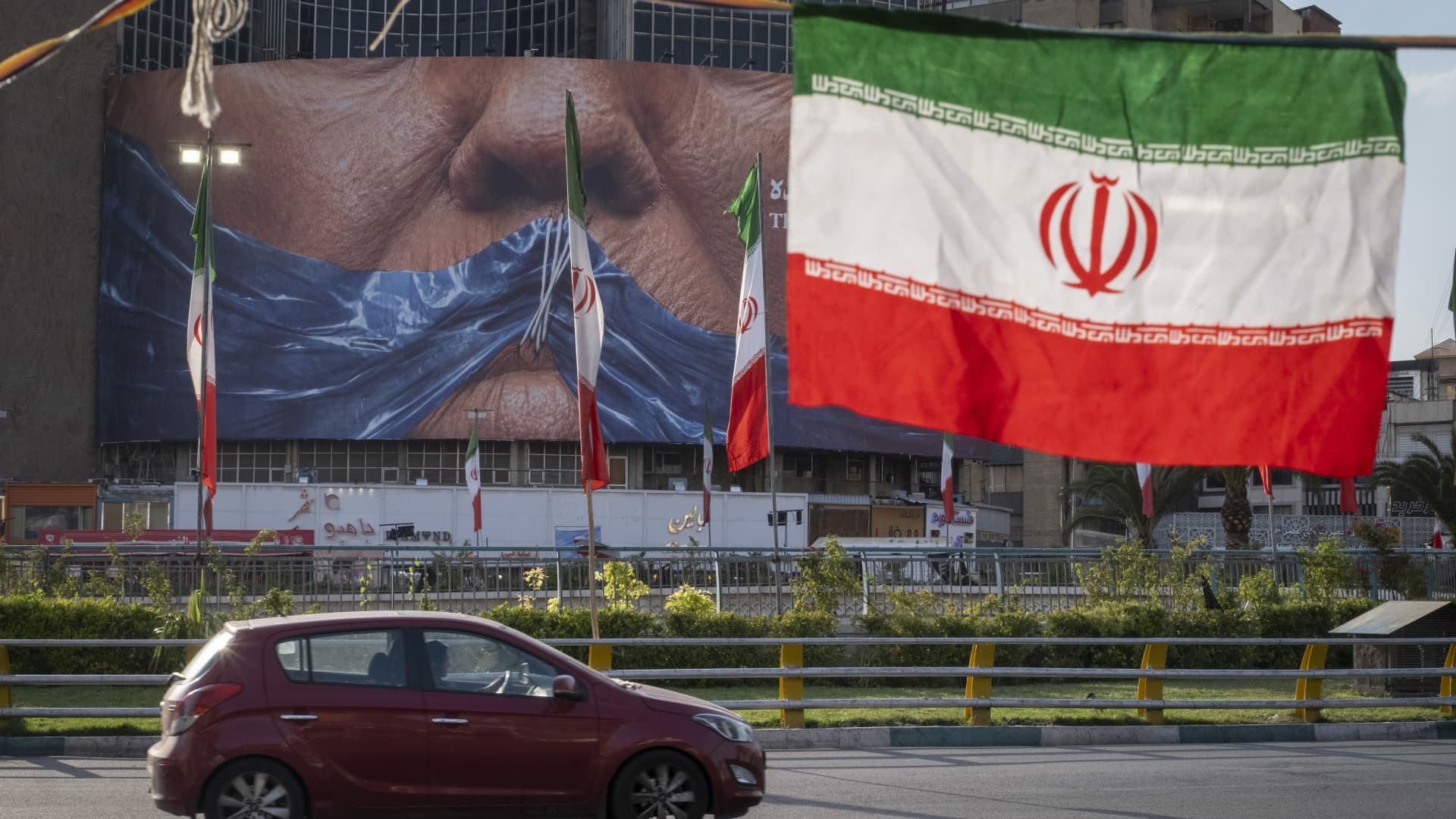 Iranian shipping containers and crude oil tankers in the Strait of Hormuz representing the US-Iran 14-point memorandum negotiations that crashed WTI 7% to $95.08, ThriveInMarkets daily morning analysis May 7 2026