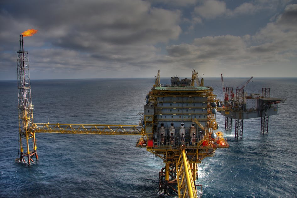 Cinematic dawn view of an oil rig pumpjack silhouetted against an amber sunrise sky, representing the WTI crude rebound to $98.93 after Trump rejected Iran's peace proposal heading into the heaviest macro week of the spring, ThriveInMarkets morning analysis May 11 2026