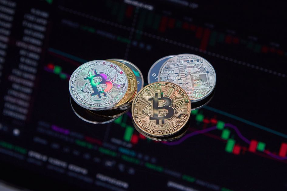 Bitcoin coins resting on a candlestick price chart screen, illustrating the June 10 2026 ThriveInMarkets morning analysis as Bitcoin slipped under 61,000 dollars toward the 60,000 dollar psychological zone amid record US spot ETF outflows of roughly 4.4 billion dollars over 13 days and the first-ever Bitcoin sale by Strategy, while Ethereum lagged near 1,619 dollars ahead of the May Consumer Price Index and the June 16 to 17 Federal Reserve meeting