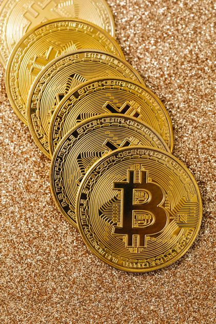 Gold-toned coins on a glittery gold surface, illustrating the June 10 2026 ThriveInMarkets morning analysis as spot gold slid to a two-month low near 4,170 dollars even as US self-defense strikes on Iran and Iranian retaliation against bases in Jordan, Kuwait and Bahrain sent WTI crude up about 2 percent toward 90 dollars, S&P 500 futures fell roughly 1.1 percent and Nasdaq 100 futures dropped about 1.6 percent, Bitcoin slipped under 61,000 dollars amid record ETF outflows, and traders braced for the May Consumer Price Index due at 8:30 a.m. ET expected to show inflation accelerating to 4.2 percent