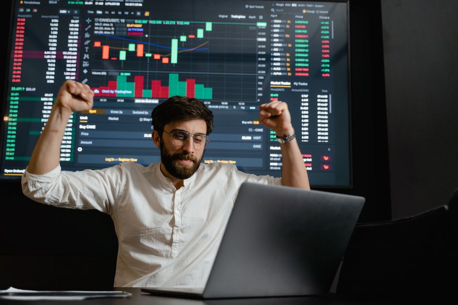 A trader at a desk surrounded by multiple glowing monitors showing market charts under dramatic warm amber and gold rim light with soft golden bokeh, representing the ThriveInMarkets morning analysis for Monday July 13 2026 as U.S.-Iran strikes escalate over the Strait of Hormuz lifting WTI crude toward $73.80, S&P 500 futures slip, SK Hynix shares tumble in Seoul and Bitcoin trades near $62,770
