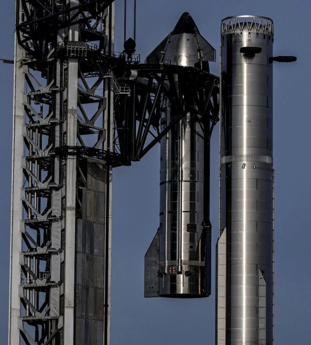 A pair of SpaceX Starship stainless-steel upper stage and Super Heavy booster vehicles standing tall beside the launch tower under a clear sky, used for the ThriveInMarkets morning analysis for Thursday August 6 2026, the day SpaceX's post-IPO lock-up period expires and frees roughly 101 billion dollars of insider and early-investor shares to trade after the newly public stock sank about 14 percent on Wednesday over its roughly 18.4 billion dollar quarterly capital-expenditure bill, while the Dow Jones Industrial Average closed at a fresh record 54,349.12 and the S&P 500 slipped to 7,723.55 and the Nasdaq Composite eased to 26,363.44, West Texas Intermediate crude traded near 74.79 dollars, gold held close to a record 4,260 dollars, Bitcoin traded near 64,736 dollars and Ether near 1,911 dollars ahead of Friday's July jobs report