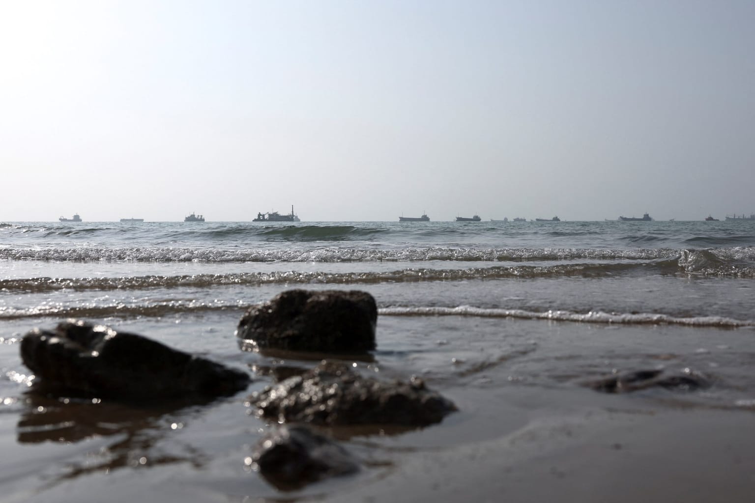Vessels sit on the horizon off a rocky beach in the Strait of Hormuz near Bandar Abbas, Iran, used as the ThriveInMarkets morning analysis hero for Monday September 7 2026, when West Texas Intermediate held near 92.62 dollars after US forces struck three Iranian oil tankers over the weekend and Iran said a new restricted zone outside Hormuz would be declared in coming days, as US cash sat out Labor Day with overnight E-mini S&P 500 futures near 7,721 against Friday's 7,718.60 close