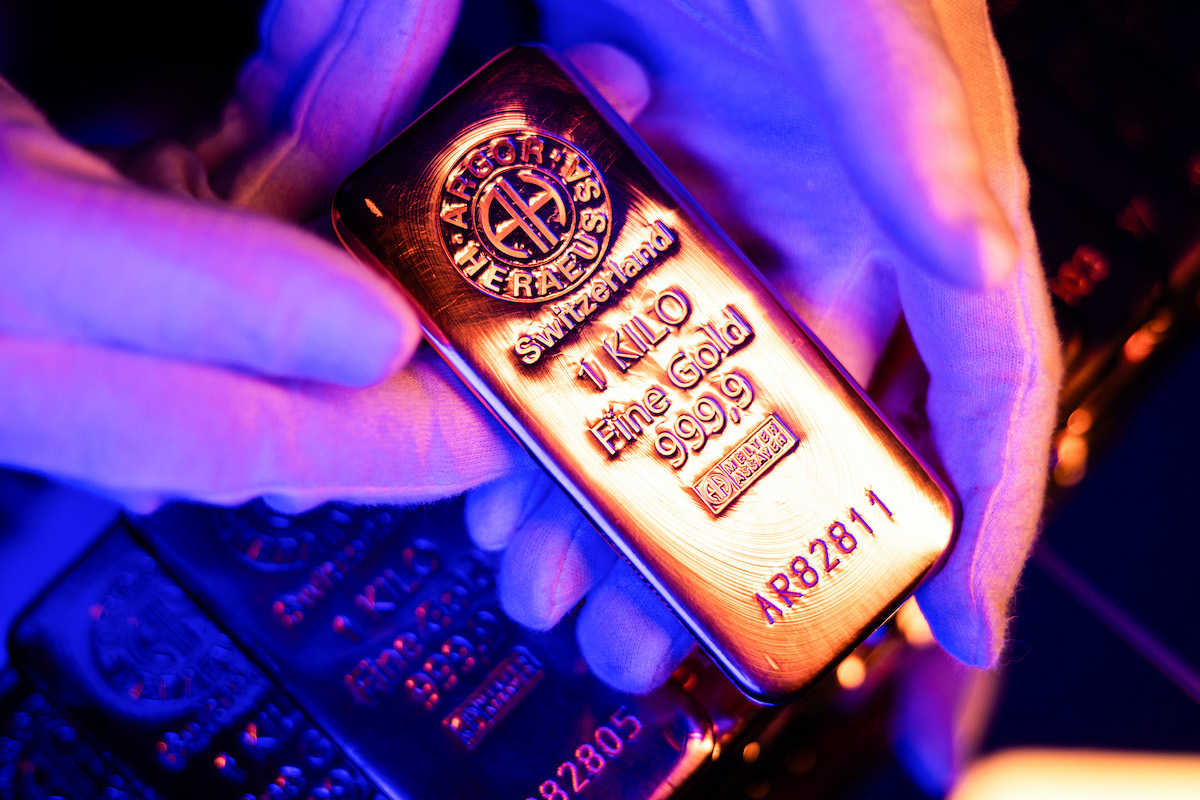 Gloved hands hold a 1 kilo Argor-Heraeus fine gold bar under purple light, used as the ThriveInMarkets morning analysis inline image for Tuesday October 13 2026, when spot gold last printed about 4,192 dollars ahead of Wednesday's September CPI